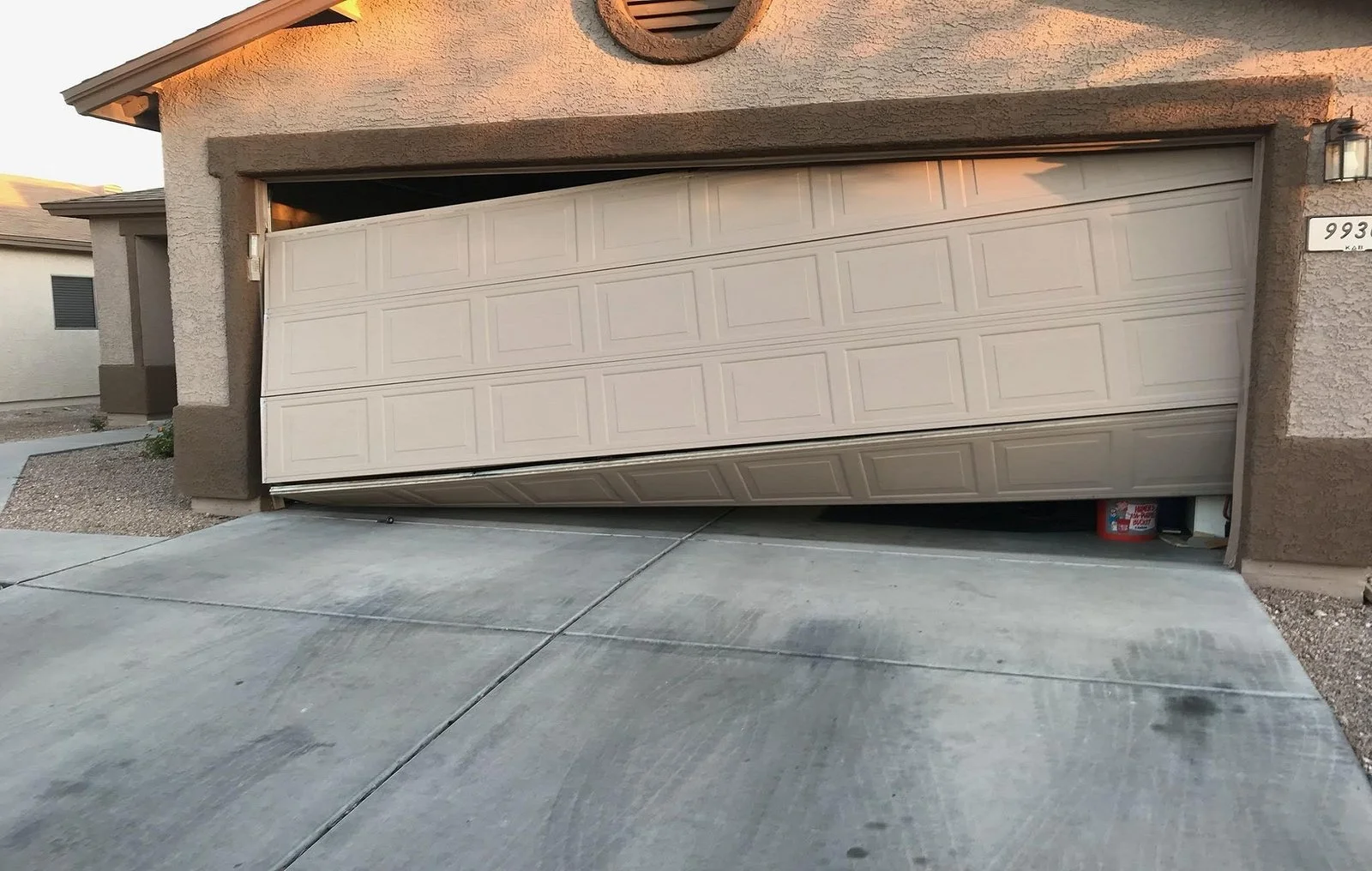 Bent garage door panels showing when garage door replacement may be needed in Long Beach