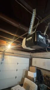 Close-up of garage door torsion spring and cable system connected to the cable drum