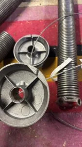 Garage door torsion spring and cable repair inspection for accurate spring repair pricing