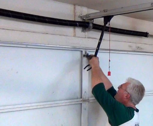Technician working on a residential garage door system